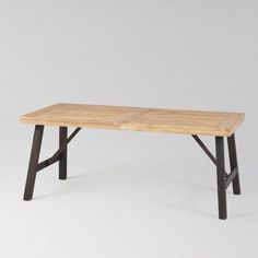 a wooden table sitting on top of a white floor