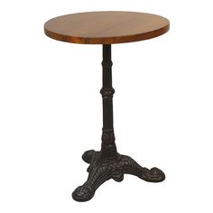 an old fashioned wooden table with black metal legs and a round top, on a white background