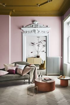 a living room with pink walls and furniture