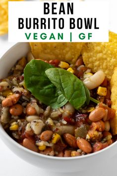 bean burrito bowl with tortilla chips and spinach leaves on the side