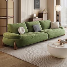 a living room with a green couch and white rug