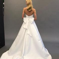 a woman in a white wedding dress looking back