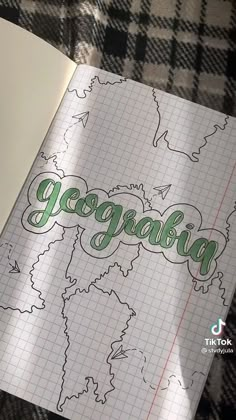 an open notebook with the word georgia written in cursive writing on top of it