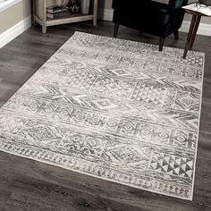 a large white rug in the corner of a room