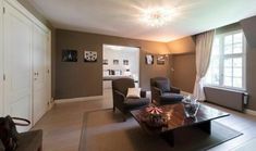 a living room filled with furniture and a chandelier