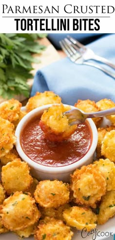 a white plate topped with tater tots covered in tomato sauce