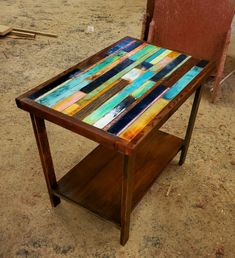 a small wooden table sitting on top of a dirt ground