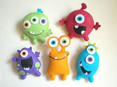 five different colored stuffed animals with big eyes