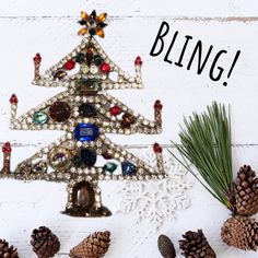 a christmas tree made out of beads and pine cones with the words bling on it