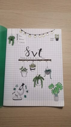 an open notebook with plants on it