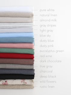 a stack of folded linens on top of each other in different colors and sizes