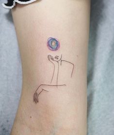 a woman's foot with a small tattoo on her left leg and a flower in the middle