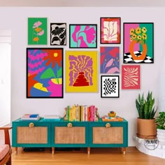 a living room filled with lots of art on the wall