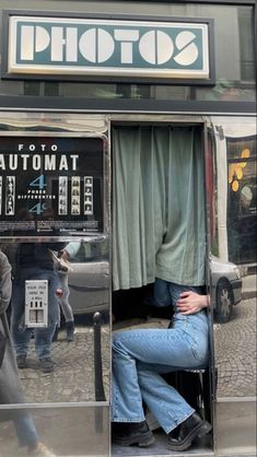 a man sitting in an atm machine on the street