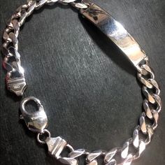 New Thick Heavy Solid 925 Silver Italian Curb Id Link Chain Bracelet Style : Thick Curb Id Link Bracelet Metal Type : 14k White Layer On Solid .925 Sterling Silver Approx. Length : 9.5" Inches Approx. Width : 0.31" Inches ( 8.0 Mm ) Approx. Thickest : 0.11" Inches ( 2.9 Mm ) Approx. Weight : 27 Grams To 28 Grams Region Imported From: Italy Clasp : Lobster Clasp Item # : Jn10161712-Shop-912-Bb December Jewelry, Italian Bracelet, Bracelet Metal, Link Chain Bracelet, Bracelet Style, Metal Bracelets, Chain Link Bracelet, Solid 925 Sterling Silver, 11 Inches