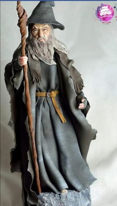 a statue of an old wizard holding a staff