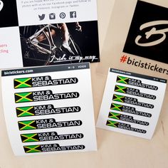 two stickers on the side of a white and black bike with green and yellow stripes