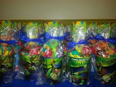 some plastic cups and bags filled with candy