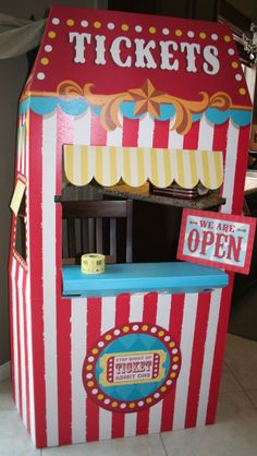 a red and white striped carnival ticket booth