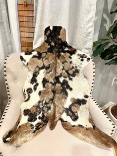 an animal print rug sitting on top of a white chair