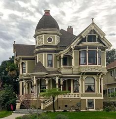 an old victorian style house on a cloudy day