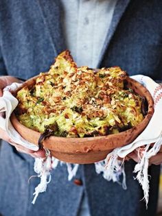 a person holding a bowl filled with food