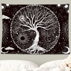 a tapestry hanging on the wall above a bed