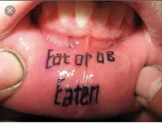 someone has written on their foot with the words eat or be eaten in black ink