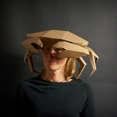 a woman wearing a paper hat made to look like a crab