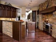 a kitchen with wood floors and stone walls