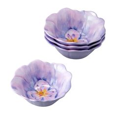 two purple flower bowls sitting on top of each other