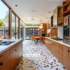 a kitchen with lots of counter space and wooden cabinetry, along with an outdoor dining area