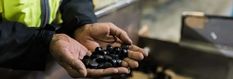 a person holding some black objects in their hands