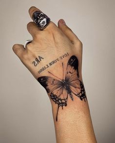 a person's hand with a butterfly on it and the words love is your salvation