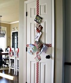 a white door with red and white ribbon on the front, and pictures hanging from it's side