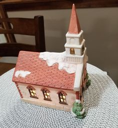 a small house with a red roof on a table