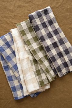 four different colored checkered cloths laying on top of each other