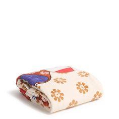 two blankets folded on top of each other in different colors and patterns, one with an owl