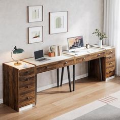 a wooden desk with two drawers and a laptop on it in front of a window