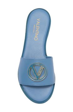 A signature logo buckle gleams at the vamp of a chic slide sandal ready to elevate your poolside style. Leather upper and lining/synthetic sole Made in Italy Luxury Spring Slides, Luxury Slip-on Slides For Spring, Logo Open Toe Sandals For Summer, Trendy Slides With Buckle Closure, Trendy Flat Heel Slides With Buckle Closure, Designer Synthetic Slides Slip-on, Luxury Summer Sandals With Logo, Luxury Flat Slides With Buckle Closure, Leather Open Toe Sandals With Logo