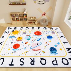 a child's room with a rug that says, abcdefghy