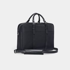 The Cary Briefcase | Single Compartment - Black | Stuart & Lau Modern Business Briefcase With Palladium Hardware, Classic Satchel Cases For Everyday Use, Classic Everyday Satchel Case, Classic Everyday Satchel Cases, Modern Briefcase With Palladium Hardware For Everyday, Modern Briefcase With Palladium Hardware, Classic Briefcase With Luggage Sleeve For Everyday Use, Classic Rectangular Laptop Bag For Everyday Use, Timeless Briefcase With Luggage Sleeve For Everyday Use