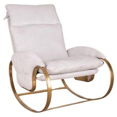 a white rocking chair with gold trimming