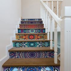 the stairs are decorated with colorful rugs on them and there is also a handrail