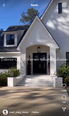 a white house with black doors and windows