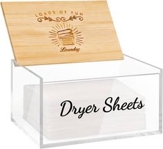 a clear acrylic box with some napkins in it that says dryer sheets