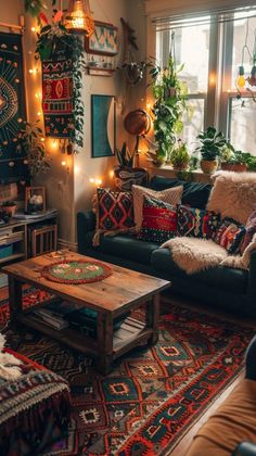 a living room filled with lots of furniture and plants on the wall above it's windows