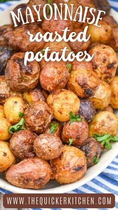 a plate full of cooked potatoes on a blue and white table cloth with the words mayonnaise roasted potatoes