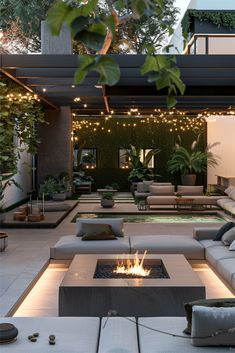 an outdoor living area with couches and fire pit