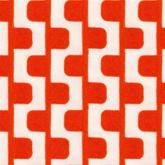 an orange and white pattern on fabric